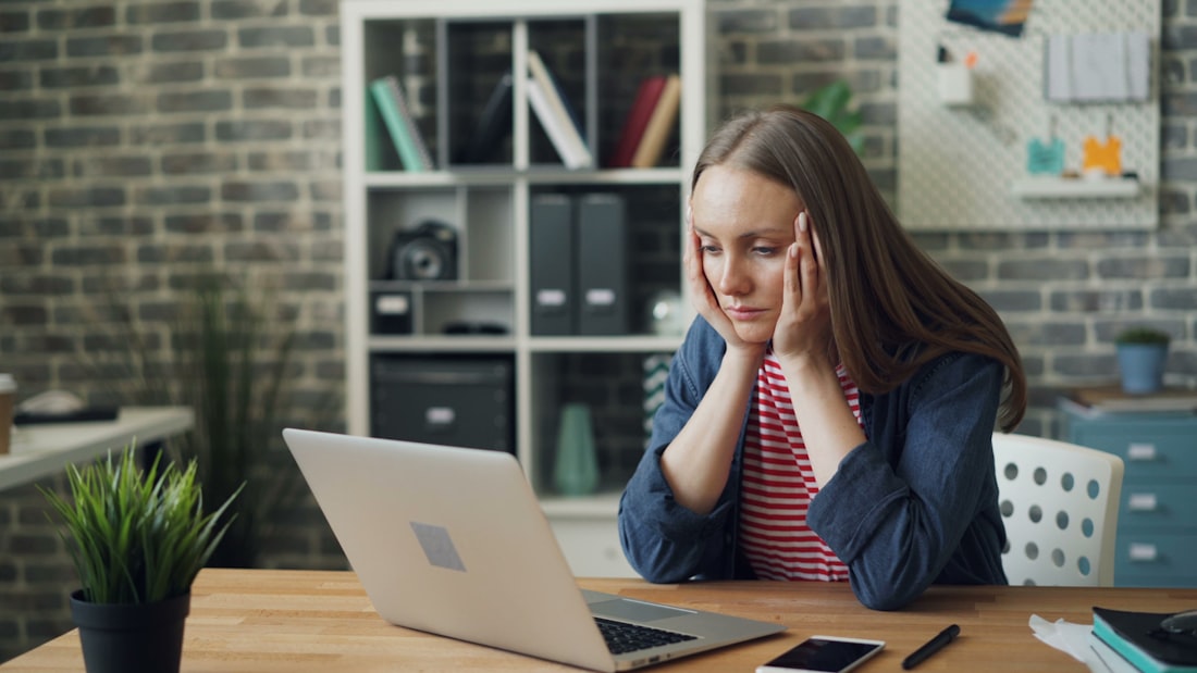 A laptop open at the kitchen table in the evening in the 21st century