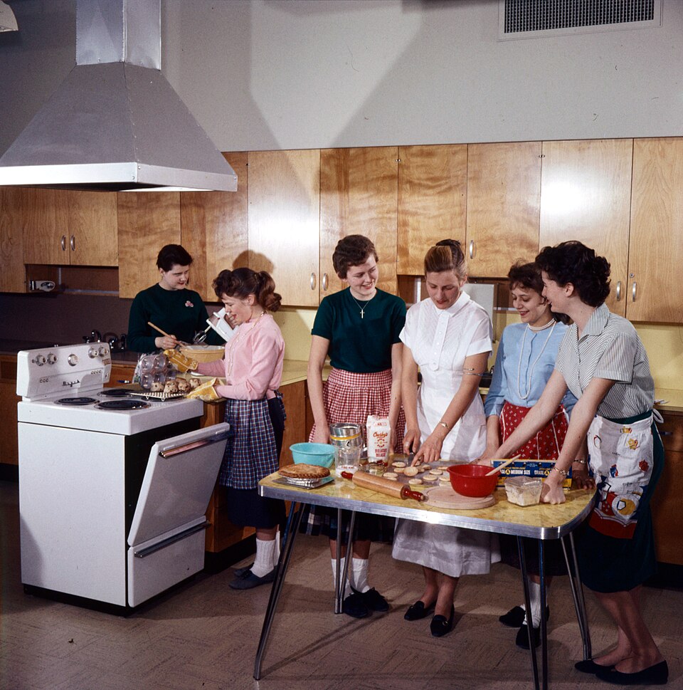 A home economics class in 1959 receiving cooking instruction