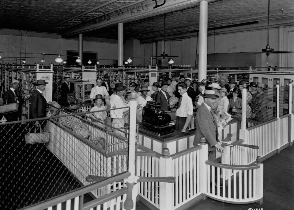 Interior of a Piggly Wiggly self-service grocery store in 1918, where shoppers first collected goods themselves