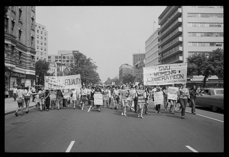 When could women get a credit card: women marching down a Washington street with banners for equality and women's liberation, 26 August 1970, black and white